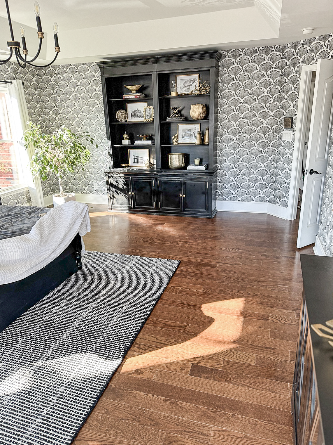Dark hardwood flooring in a finished bedroom completed by Dbest Flooring LLC