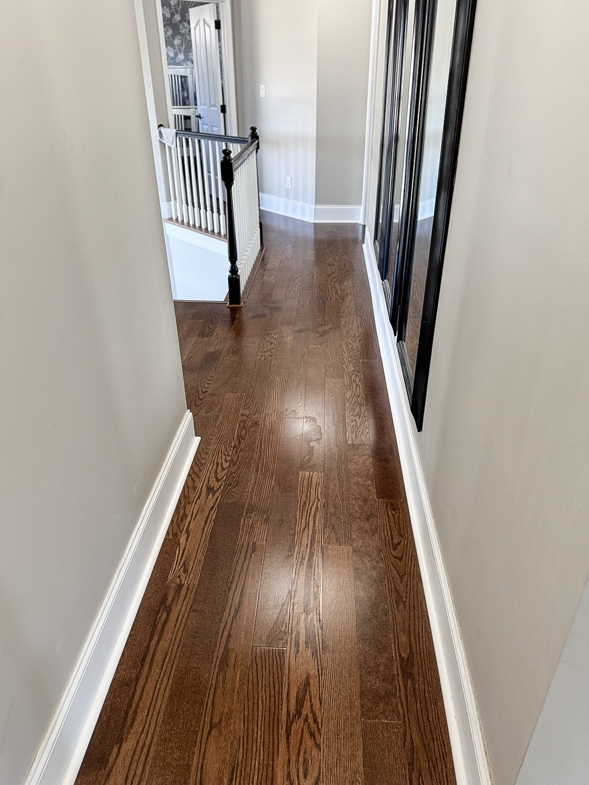 Detailed dark hardwood hallway installation completed by Dbest Flooring LLC