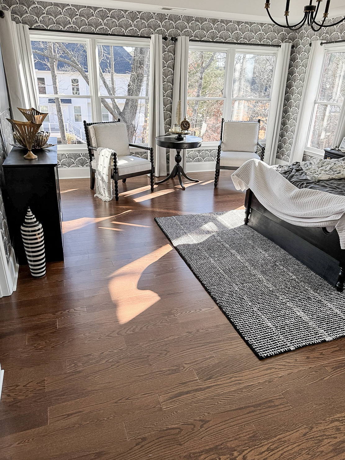 Dark hardwood flooring in a bright sitting room completed by Dbest Flooring LLC