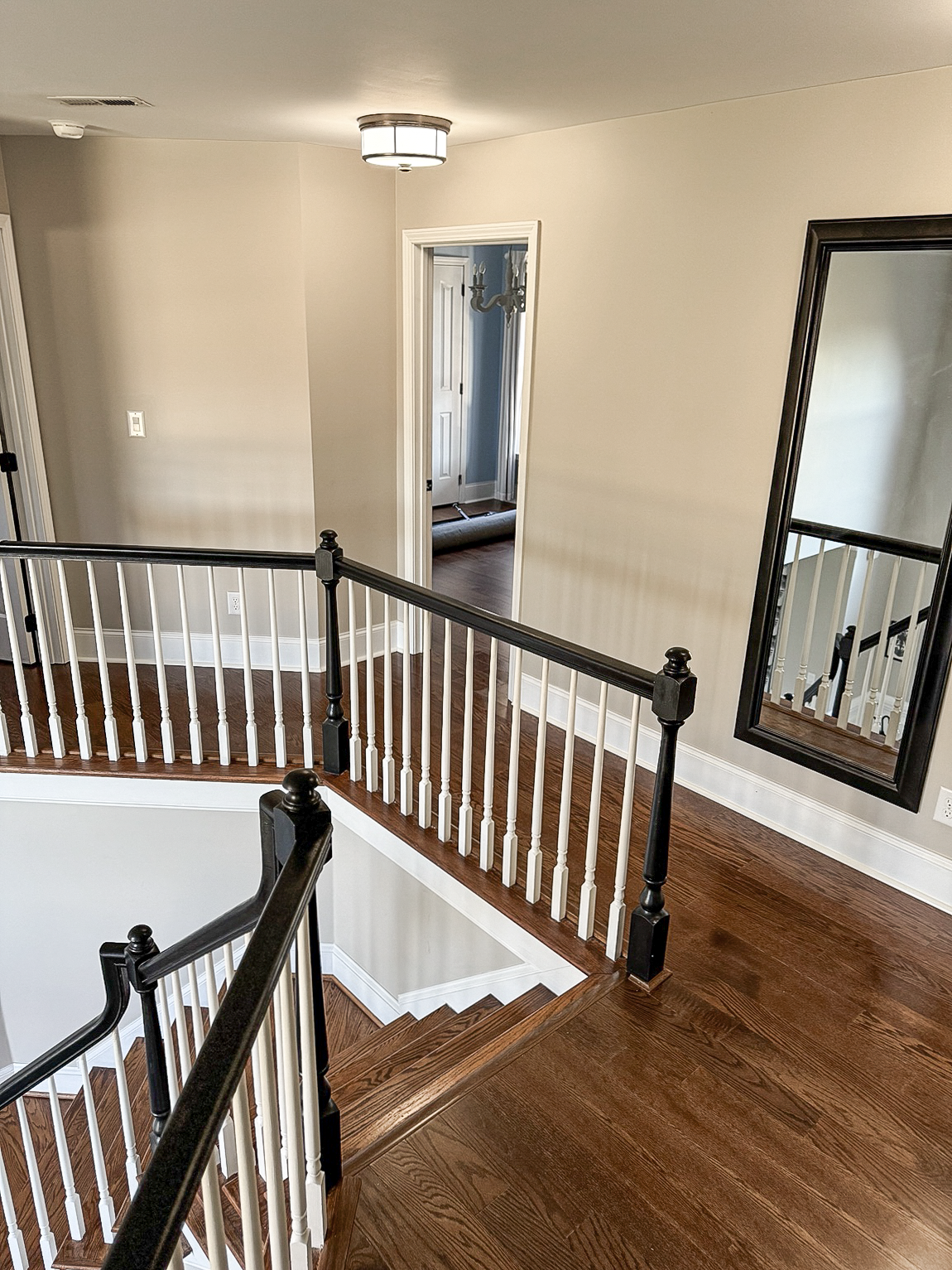 Dark hardwood stairs and landing completed by Dbest Flooring LLC